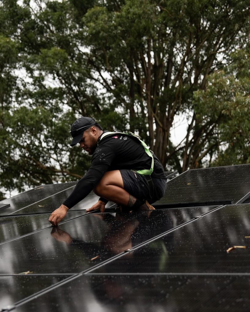 solar electrician installing a solar panel on a roof in sydney